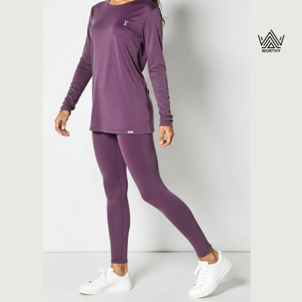 "Women's premium performance leggings in deep purple by Worthy Attire, styled with a matching top and white sneakers, perfect for activewear or casual streetwear." "Full-length women's purple leggings designed for comfort and flexibility, ideal for workouts and everyday wear by Worthy Attire." "Stylish and functional women's leggings in rich purple, paired with a casual top and sneakers for a trendy athleisure look." "High-quality breathable purple leggings for women by Worthy Attire, featuring a snug fit and durable fabric for versatile use." "Streetwear-inspired women's leggings in vibrant purple, crafted for fitness, yoga, or casual wear by Worthy Attire."