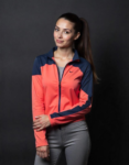 Model wearing a Women's Color-Blocked Lightweight Activewear Jacket in coral and navy by Worthy Attire, designed for comfort and style.
